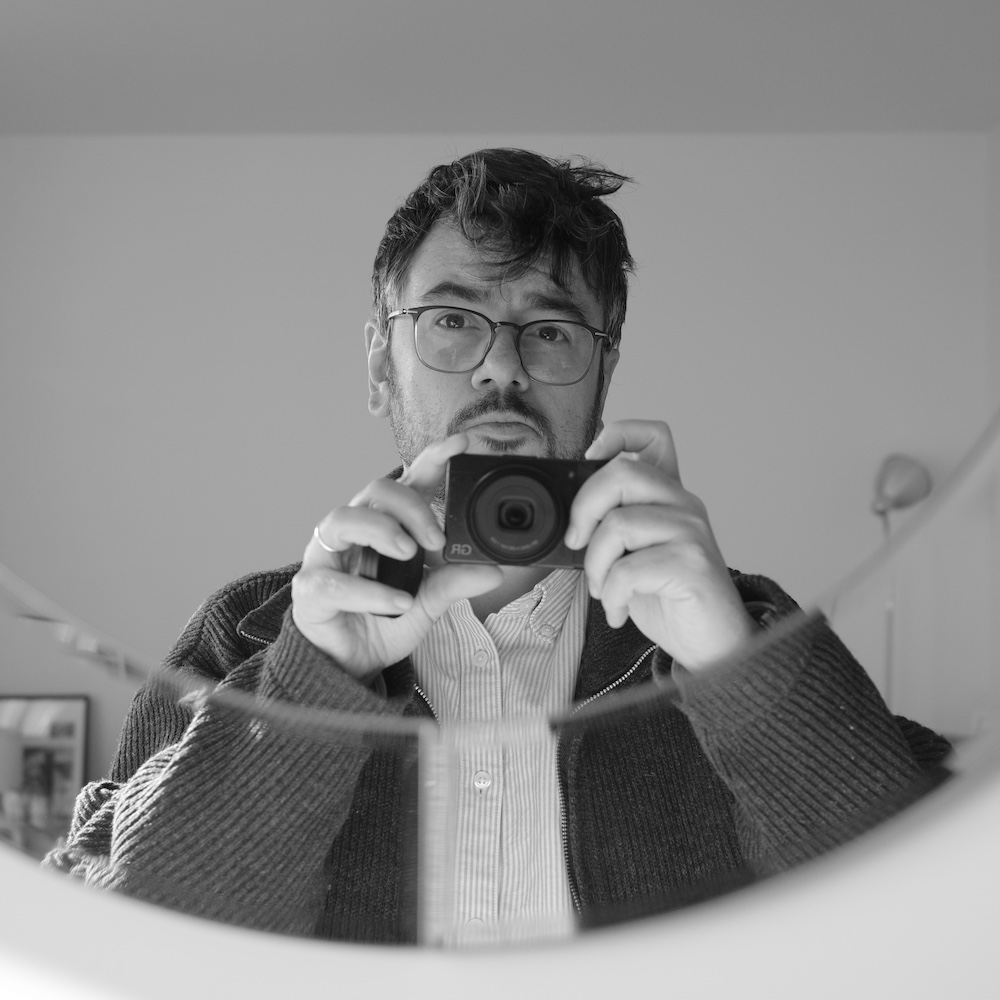 Black and white medium close-up selfie photo of Nicolas Magand